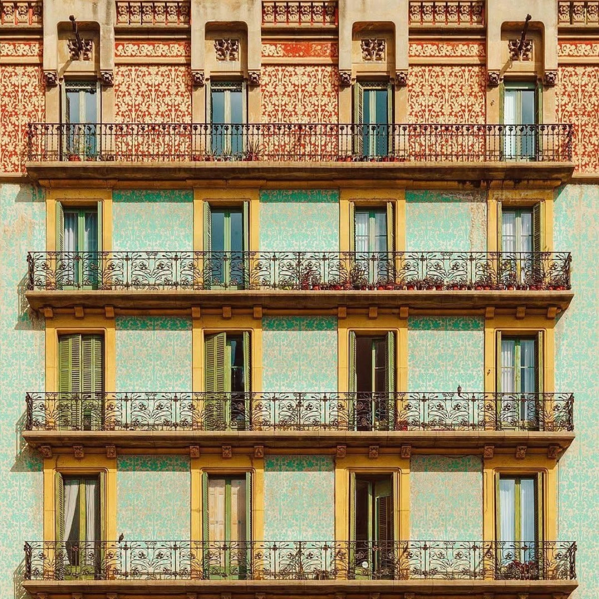 Façade colorée d’un immeuble à Barcelone avec balcons, symbole du modèle de précommande de Pamuuc.
