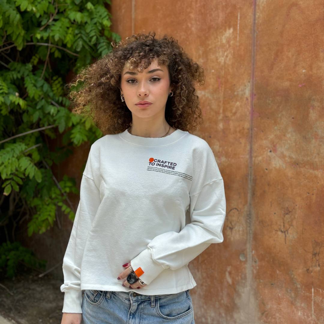 Women wearing white crewneck from pamuuc's crafted collection.